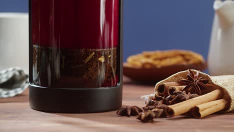 brewing black tea in a teapot close-up. drinking hot herbal drink on blue background