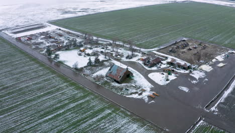 Circling-a-wintery,-snowy-farm-in-Tehachapi,-CA