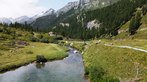 aerial view advancing through a mountain lake of turquoise clear water