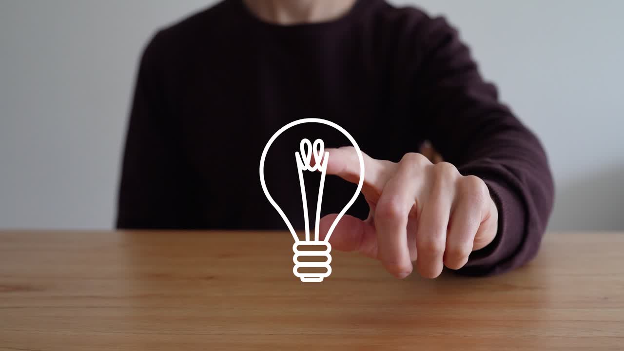 Person Taps On Glowing Light Bulb Icon On Wooden Table To Make It Disappear. New Ideas And Creativity Concept. closeup shot