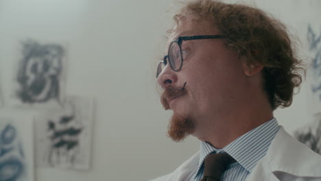 psychiatrist using pocket watch during therapy session in hospital ward
