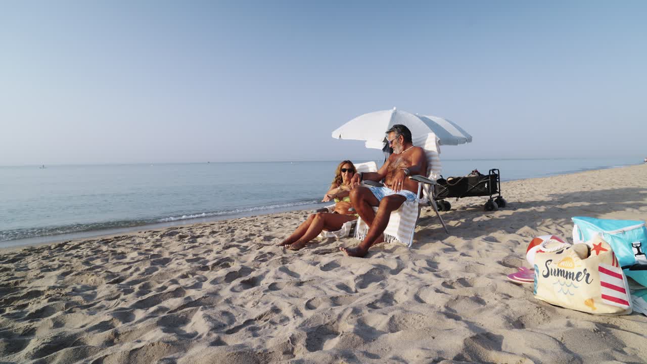 Пара отдыхает на пляже.