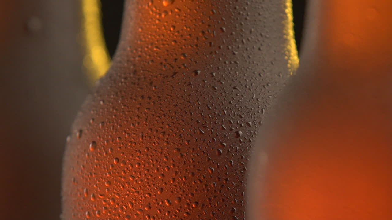 Three beer bottle rotating on black background