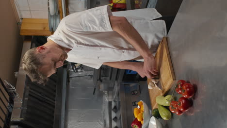 caucasian chef cutting mushrooms