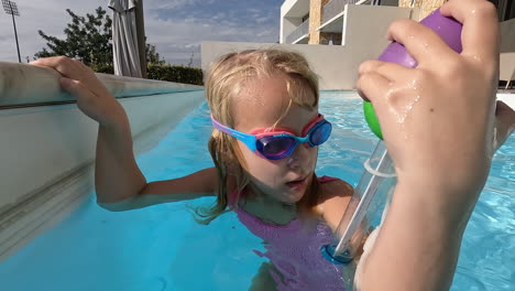 Girl-checking-pool-temperature