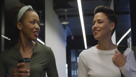 happy diverse business people discussing work and walking at office
