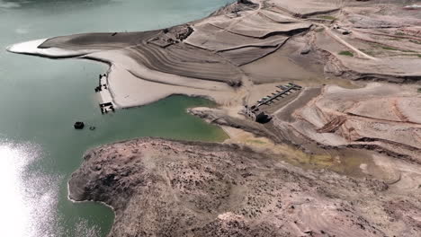 Shimmering-Sau-reservoir-Catalonia,-Spain-low-drought-water-exposed-dry-coastal-landscape-ruins