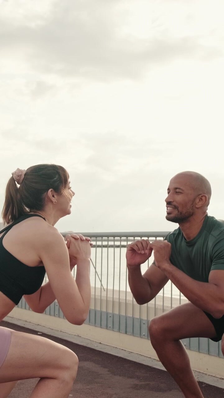 Diverse Couple Performing Squats Together Outdoors
