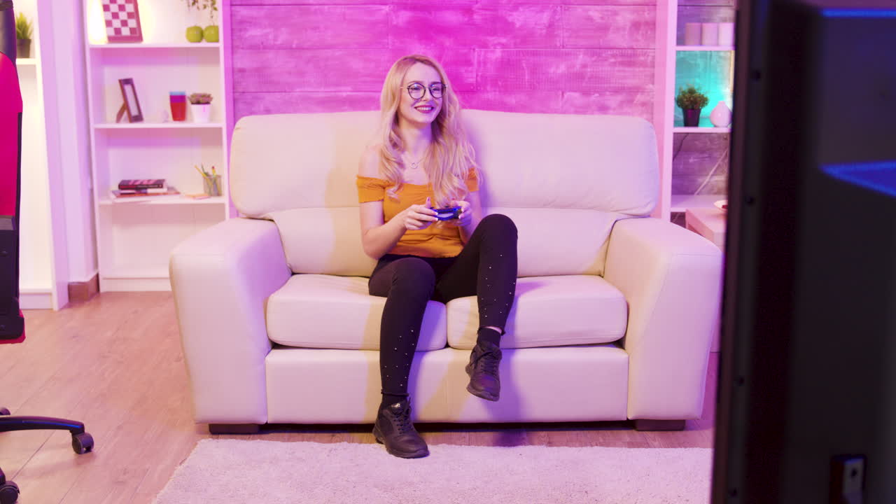 A woman playing video games on a couch
