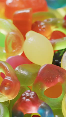 video of multicoloured candy jelly on yellow background