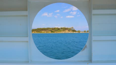 view of the sea from the cabin of a cruise liner. view of the sunset and the ocean through the porthole of the ship