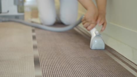 person vacuuming a carpet