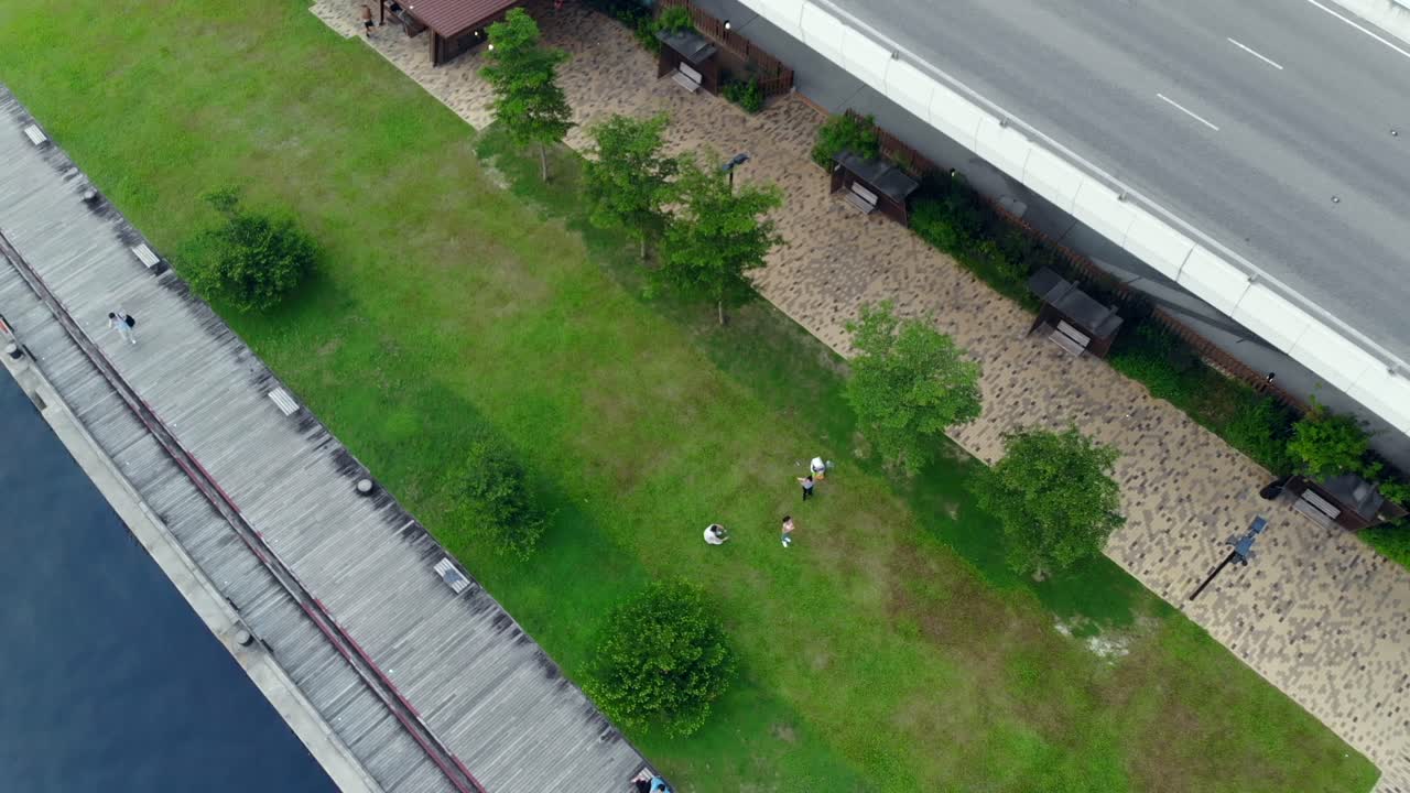 People in a park. Drone shot going away