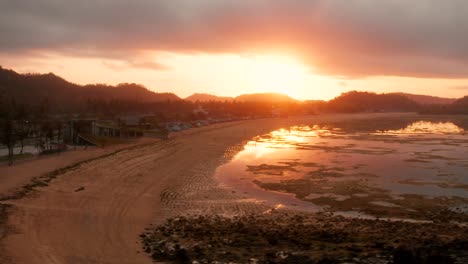 the dry reef of kuta lombok during sunrise, with local people looking for food and seashells