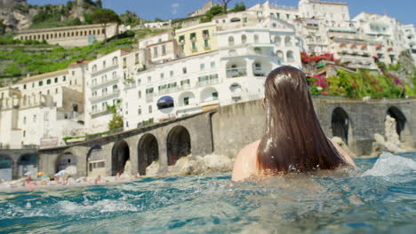 a happy young woman breaking the surface