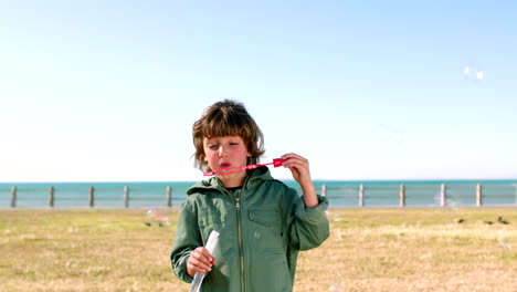 Beach,-fun-and-a-boy-blowing-bubbles-in-an-outdoor