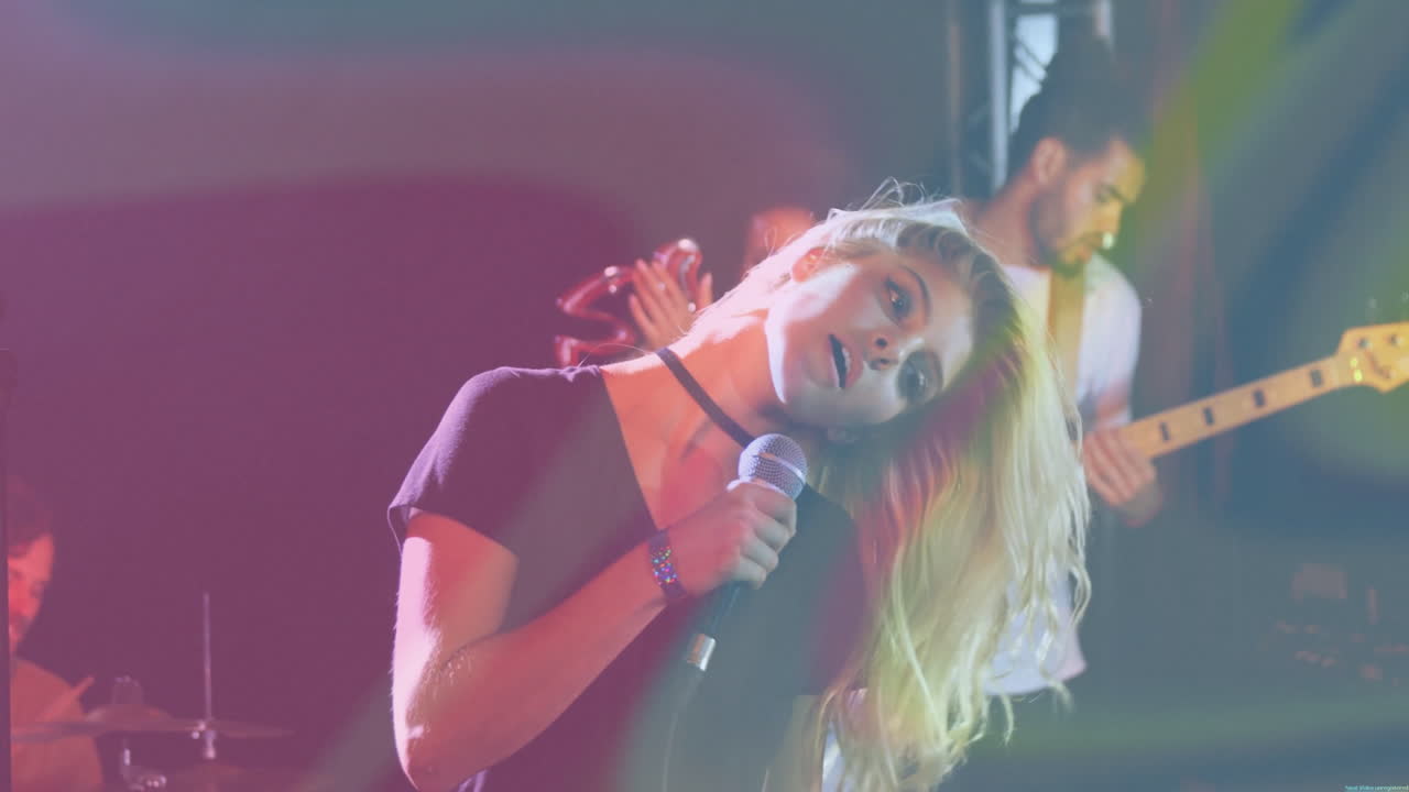 female singer leaning into microphone during live music performance, with animated sound waves