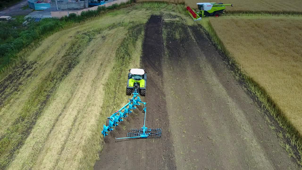 Tractor Plows The Field. VINNITSA, UKRAINE - JULY 2017: Tractor with cultivator handles field before planting