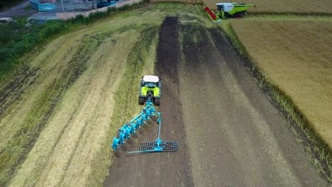 tractor plows the field. vinnitsa, ukraine - july 2017: tractor with cultivator handles field before planting