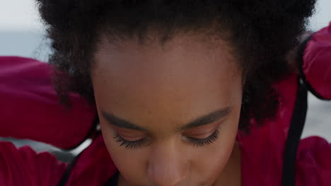 close up portrait beautiful african american woman puts on hood looking contemplative attractive black girl perfect skin slow motion