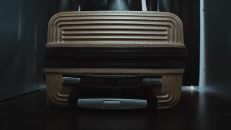 luggage in a dark room with blinds