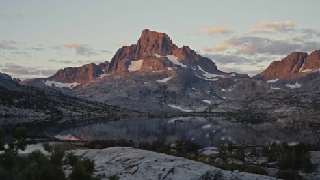 mountain view at dusk along the john muir trail with rugged peaks, rocky foreground, and soft light