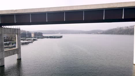 epic aerial drone shot flying under ozarks lake bridge in missouri