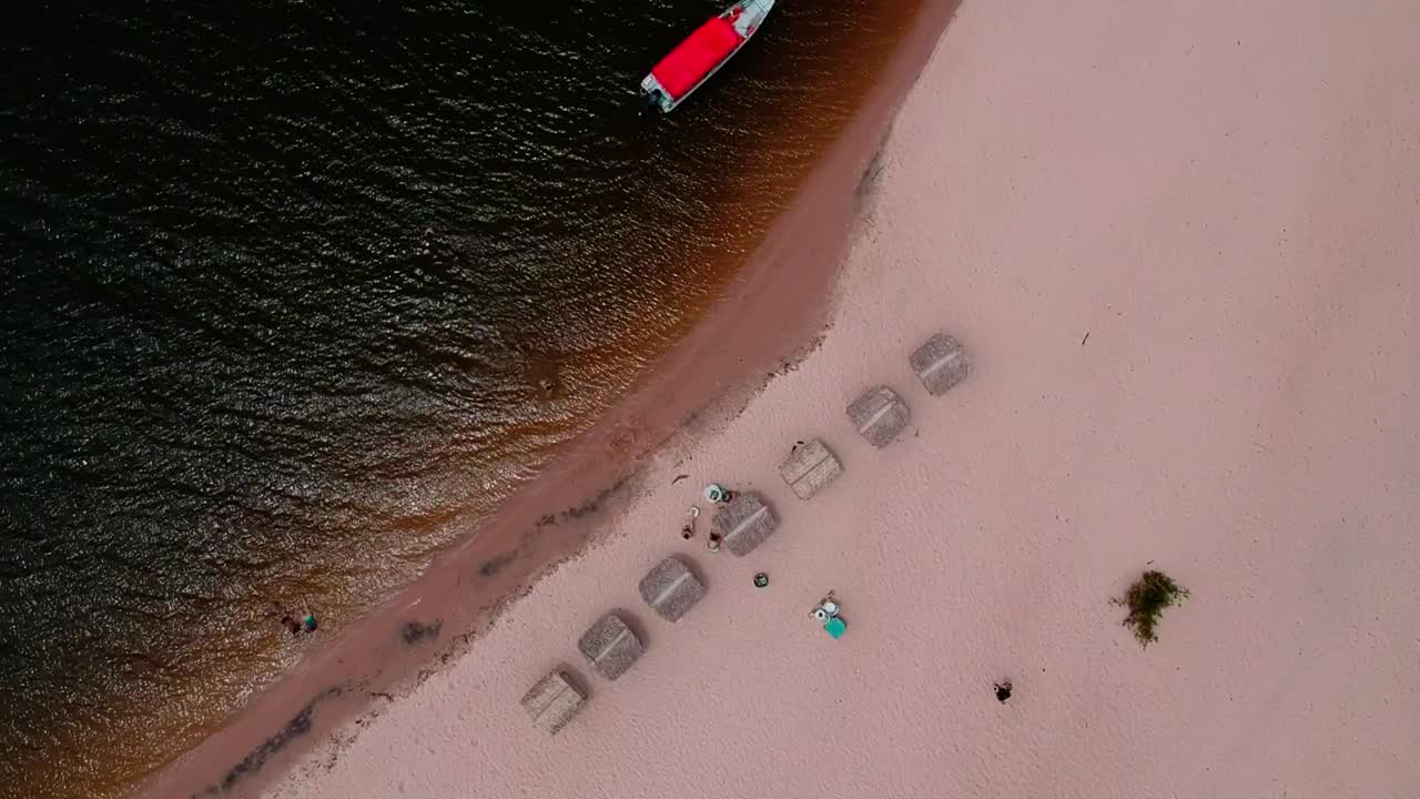 People playing on a sandy beach on the Tapajos River in Brazil's Amazon Basin near the city of Alter do Chao in the Brazilian State of Para.