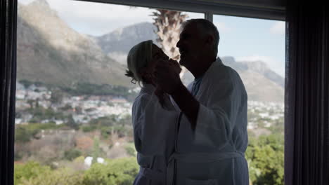 senior couple enjoying a romantic moment by the window