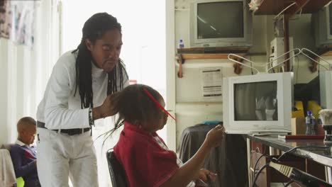 african man styling the hair of a african woman