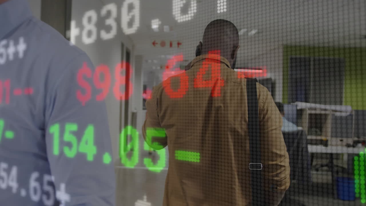 Animation of financial data overlaying person walking in modern office hallway