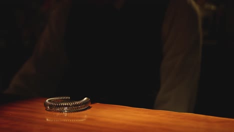 a person adds ice to a glass at a bar