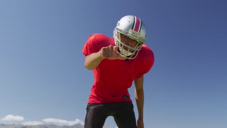 american football player standing with helmet