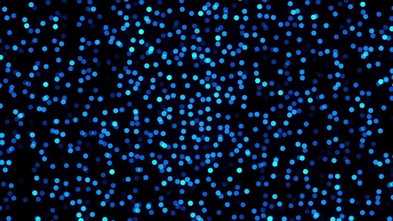 검은색 배경에 반이는 다채로운 입자의 추상적인 애니메이션, 아름다운 보케 빛의 배경, 애니메이션, 마법의 반이는 빛으로 반이는 화려한 입자, 끊임없는 루프.