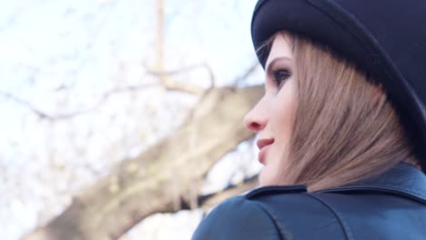 woman in black hat in park