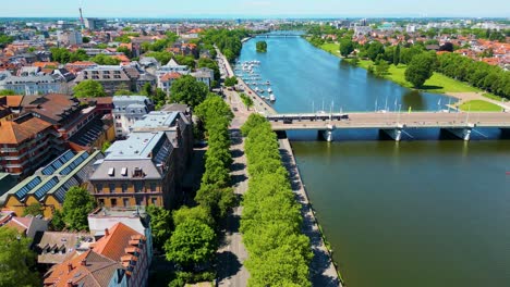 4k aerial drone video of historic homes, shops, and churches along the neckar river in downtown heidelberg, germany