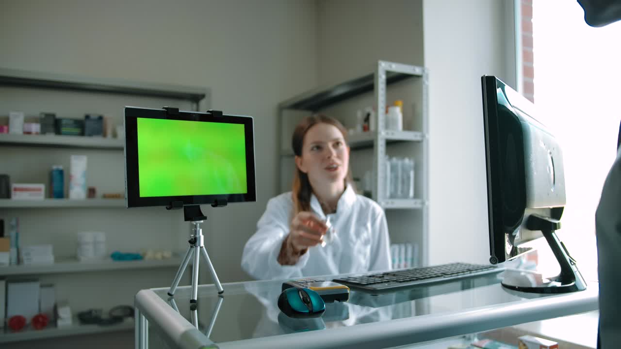 Buyer paying for coronavirus vaccine by credit card with green screen tablet PC
