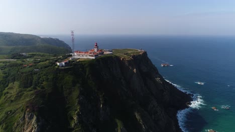 drone flying over high hill rocks top view atlantic ocean shores around cape cabo da roca in sintra portugal lighthouse westernmost point of eurasian continent beautiful archipelagos natural scenery