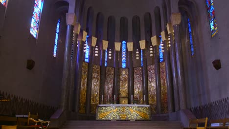 stunning interior of a modern church with gold altar and stained glass windows