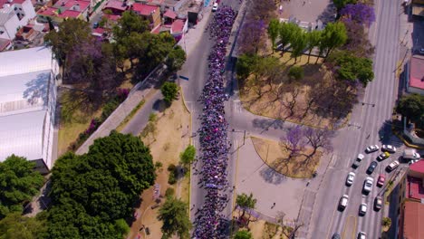 Aerial-footage-of-the-womans-day-march-in-the-main-street-of-Puebla-city