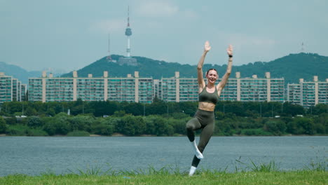 funny moment - yoga woman fail to balance in tree pose at han river park - front view