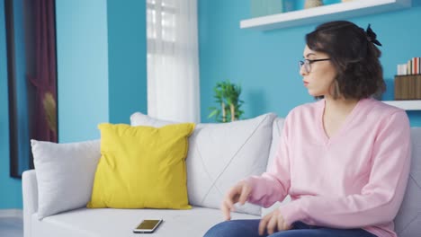 Sad-young-woman-texting-using-phone.