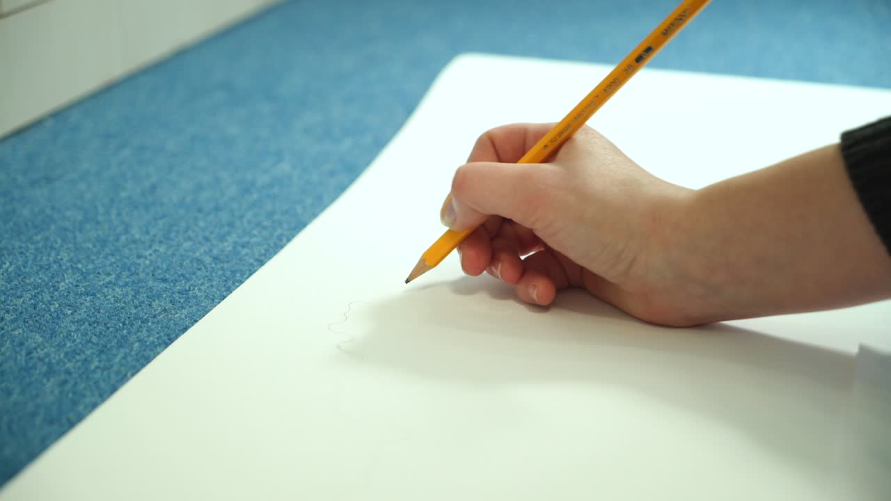 Young woman learns to draw. Artist drawing with pencil.