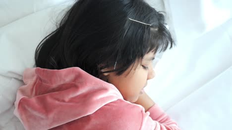 little girl sleeping in a bed