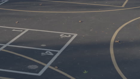 Overhead-view-of-schoolyard-blacktop-with-four-square-and-basketball-court-lines