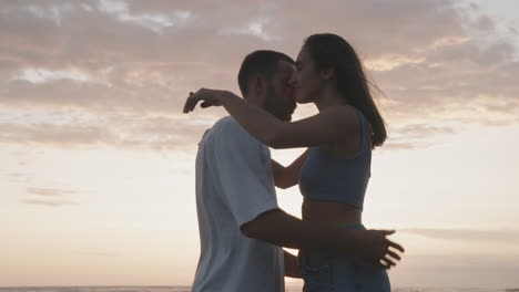 couple kissing on sunset