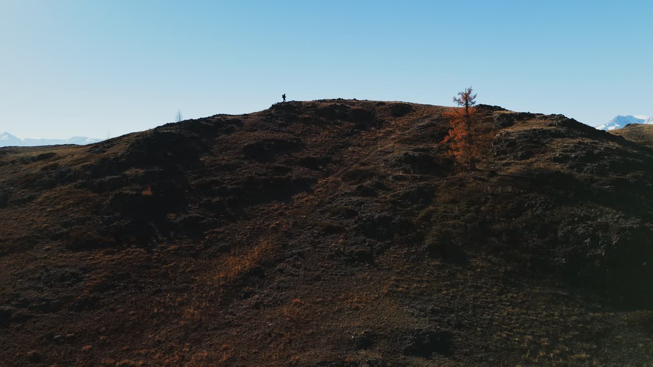 Hiker on a Mountain Top in Autumn