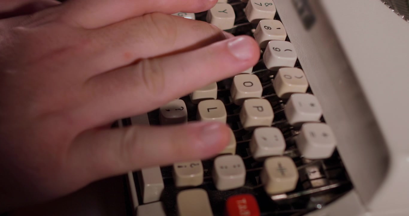 Close-up of Hands Typing on a Vintage Typewriter