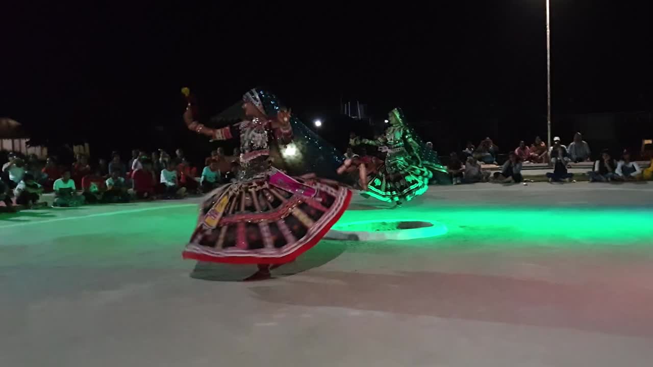 Two women performing Kalbeliya dance for a group of tourists. It is an integral part of Kalbelia culture. Live tribal folk music. The Thar Desert.