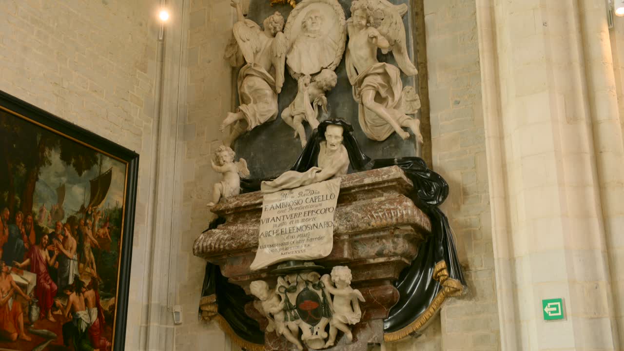 Sculptural marble tomb monument with figures and reliefs inside a historic European church